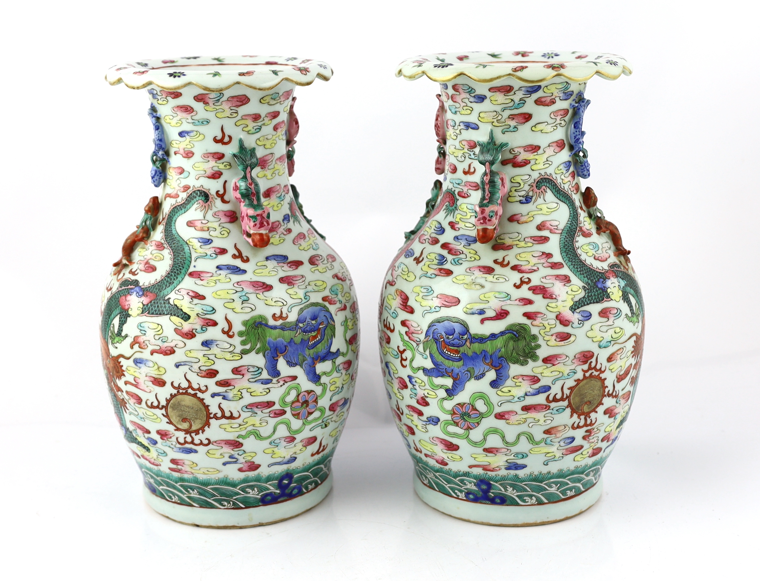 A pair of Chinese enamelled porcelain 'dragon and Buddhist lion' vases, 19th century, body crack to one vase